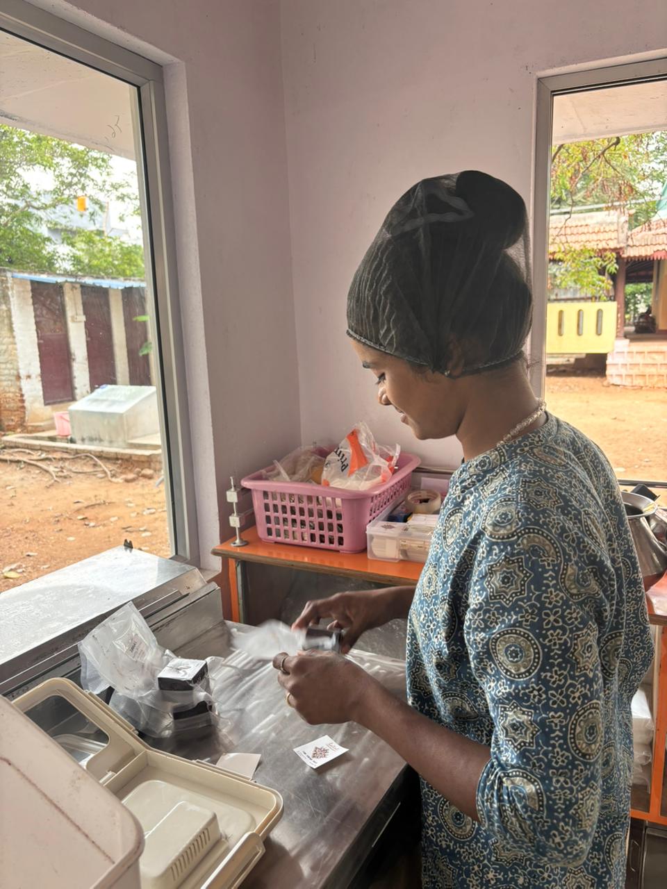 Our team member packing pure raw cacao nibs and mass at the Tiruvannamalai workshop